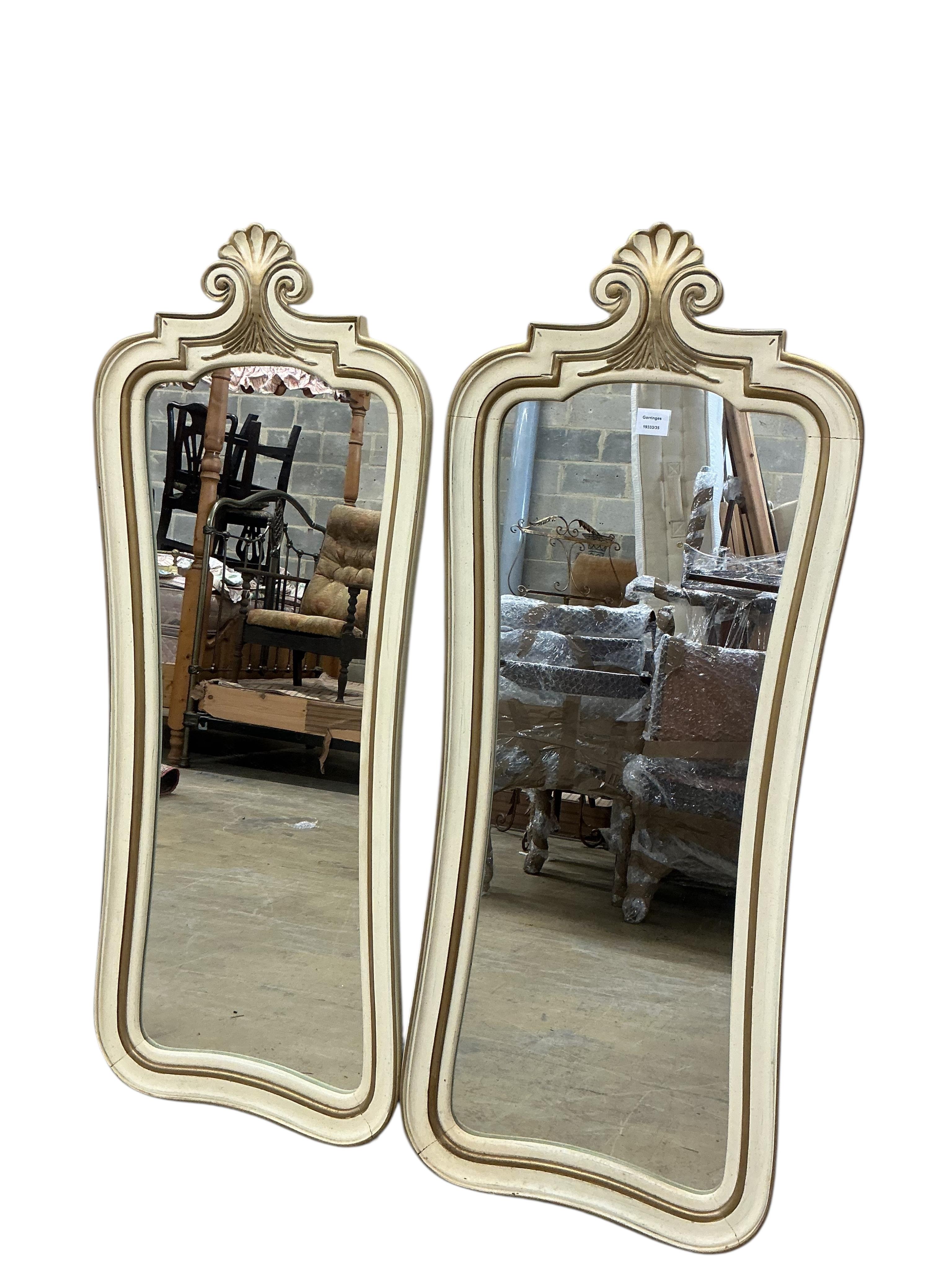 A pair of American white and gilt painted wall mirrors, width 50cm, height 130cm